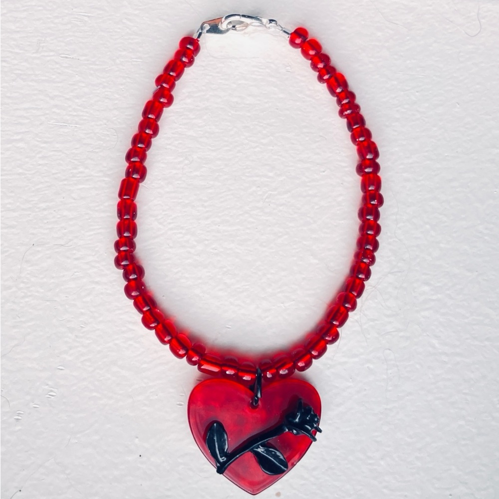 Red beaded handmade brand new bracelet with black rose heart charm
